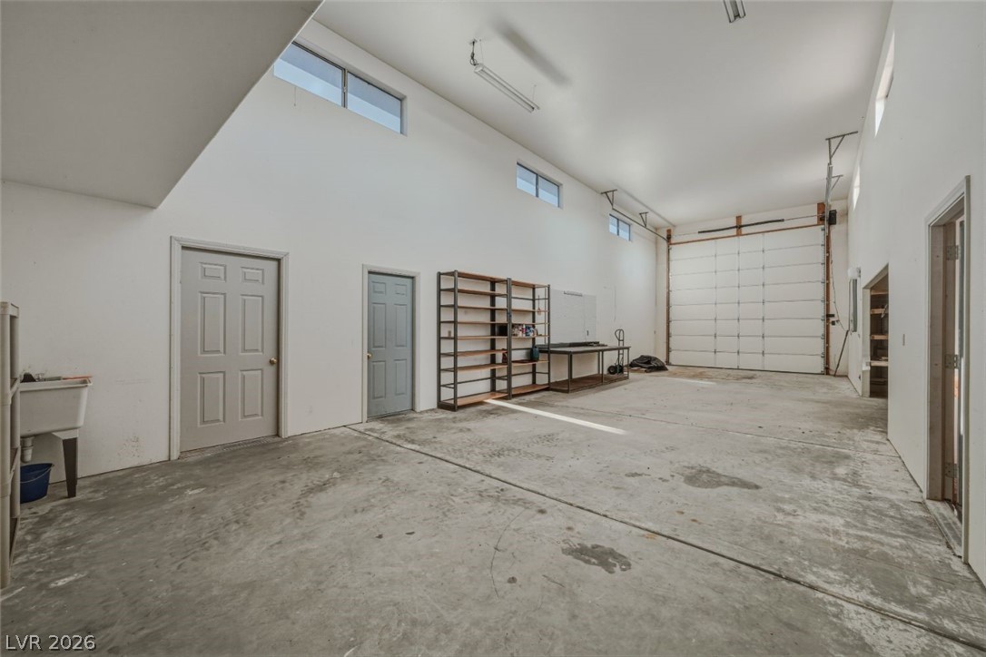 4892 Quail Run Road Pahrump, NV 89060 - Photo 72 of 90 This spacious garage offers ample room and natural light through high windows.