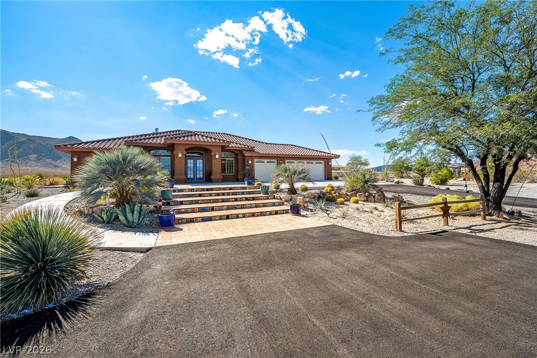 4892 Quail Run Road Pahrump, NV 89060 - Photo 86 of 90 This desert oasis features a classic tiled roof and a welcoming entryway.