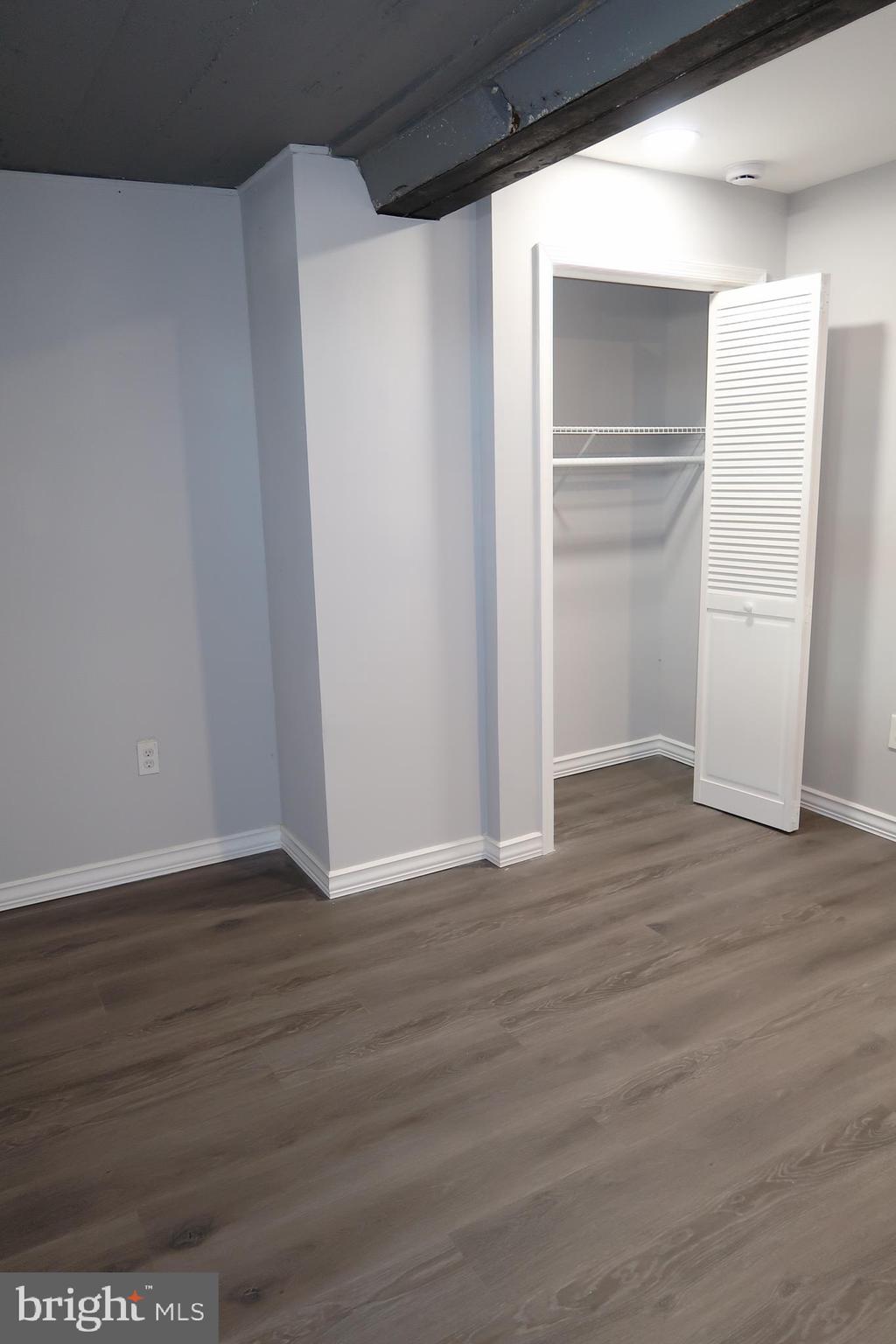 2833 Brendan Avenue, Unit 1 Baltimore, MD 21213 - Photo 17 of 26 a view of an empty room with wooden floor