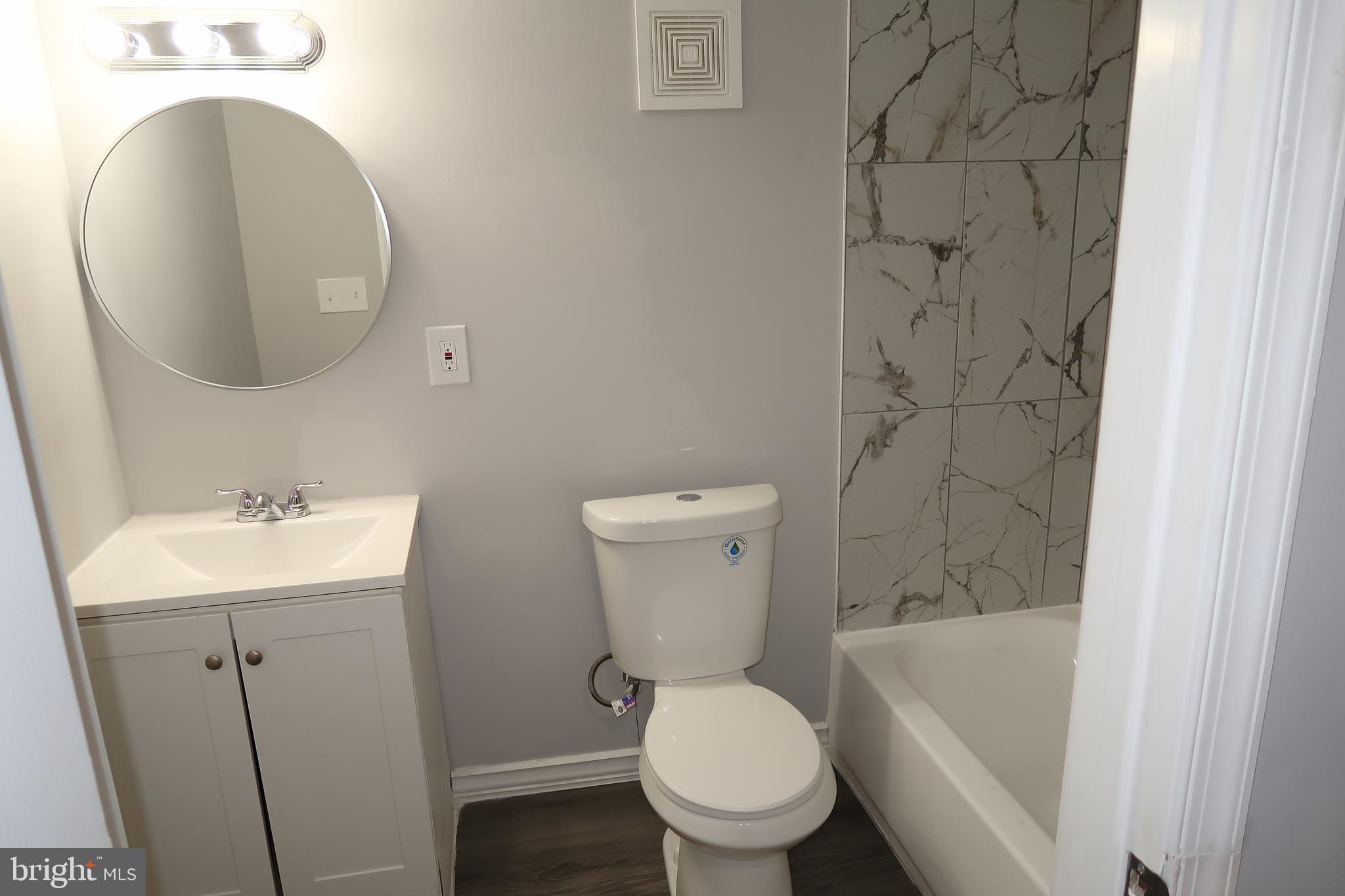 2833 Brendan Avenue, Unit 1 Baltimore, MD 21213 - Photo 19 of 26 a bathroom with a toilet sink and mirror