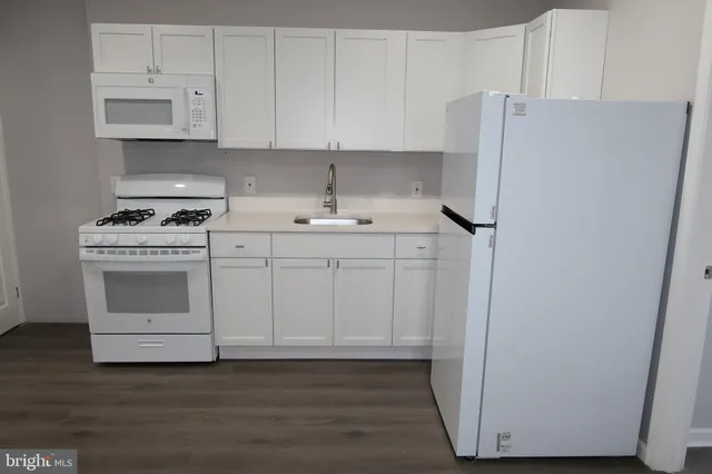 a kitchen with a white cabinets and white appliances