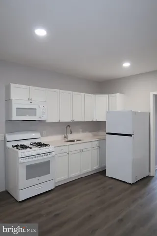 a kitchen with a white cabinets and white appliances