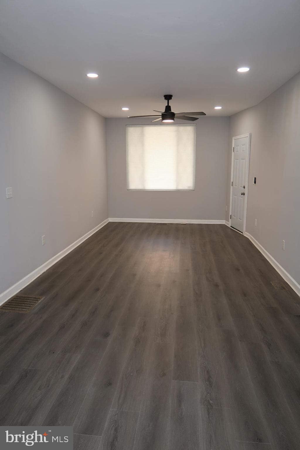 2833 Brendan Avenue, Unit 1 Baltimore, MD 21213 - Photo 8 of 26 an empty room with wooden floor and windows