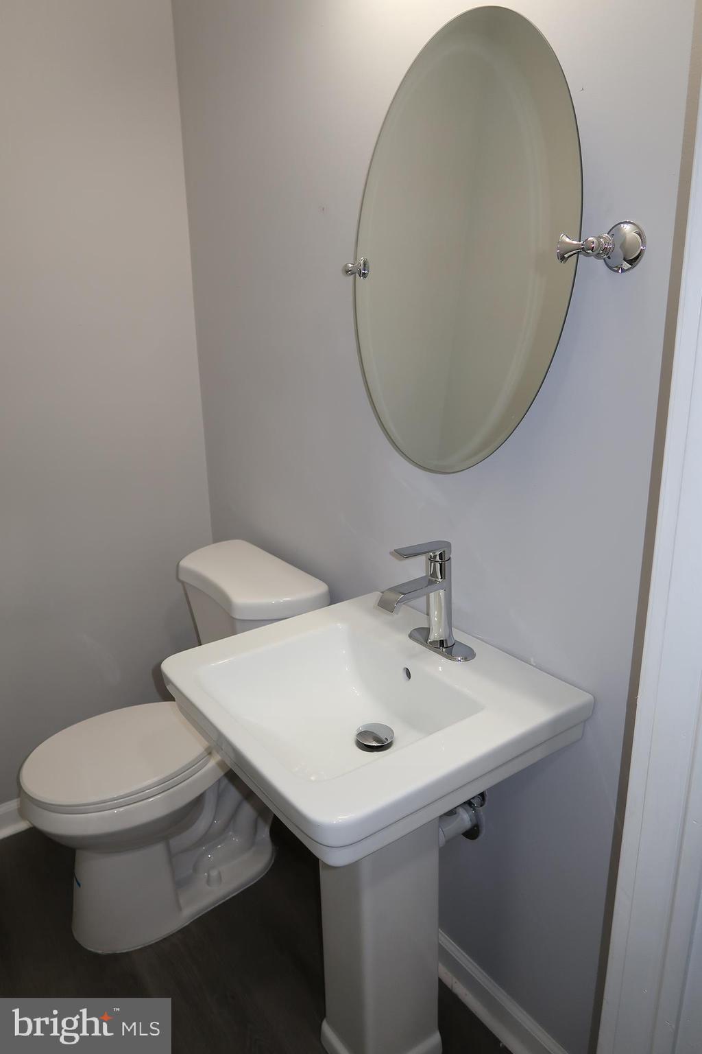 2833 Brendan Avenue, Unit 1 Baltimore, MD 21213 - Photo 10 of 26 a bathroom with a sink a toilet and a mirror