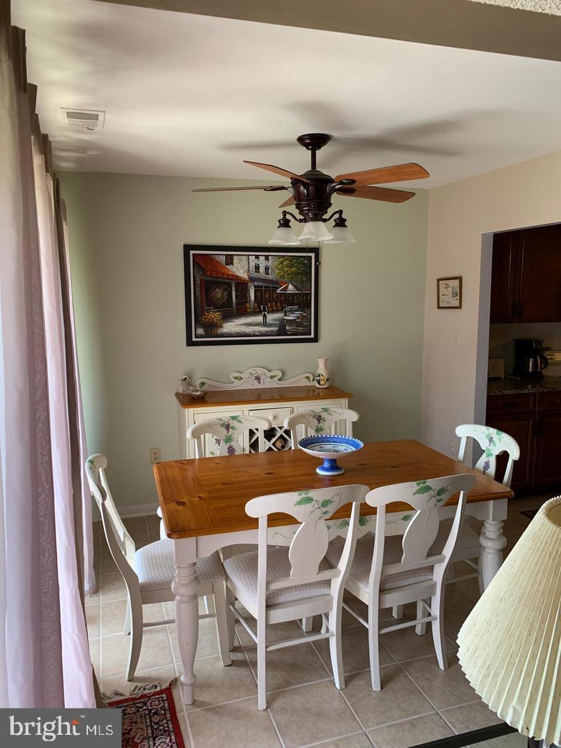 13908 North Ocean Road, Unit 8C Ocean City, MD 21842 - Photo 5 of 14 a view of a dining room with furniture