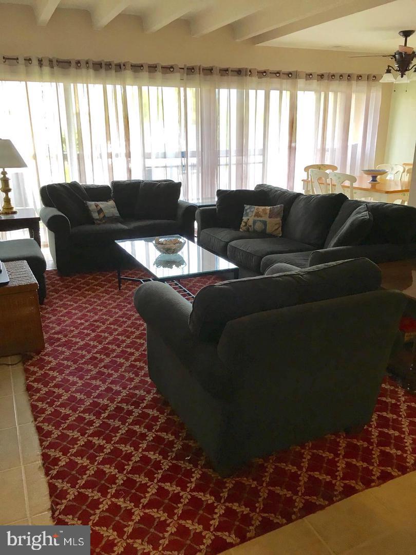 13908 North Ocean Road, Unit 8C Ocean City, MD 21842 - Photo 6 of 14 a living room with furniture and a large window