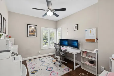 a view of a workspace with furniture and a window