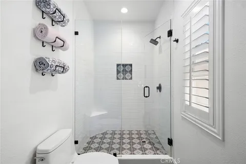 a bathroom with a shower toilet and sink