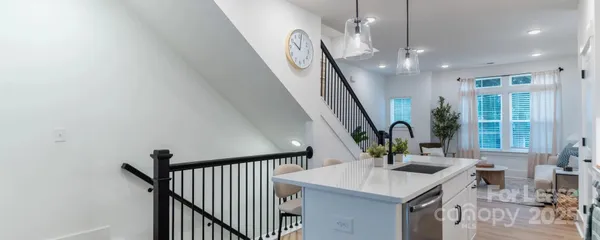 a view of a hallway with furniture and wooden floor