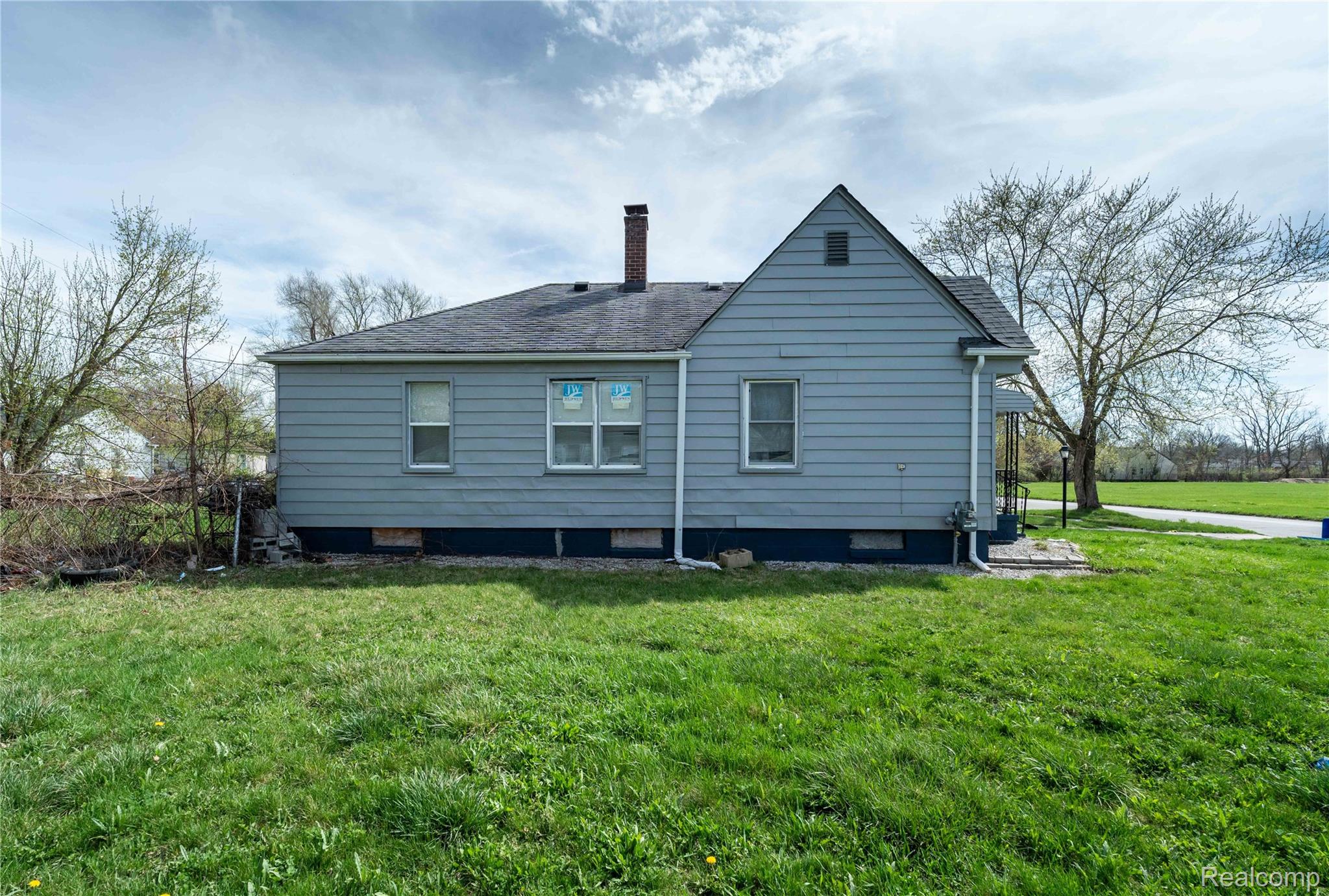4049 Williams Street Inkster, MI 48141 - Photo 19 of 21 Back of property with a yard, a chimney, and a shingled roof