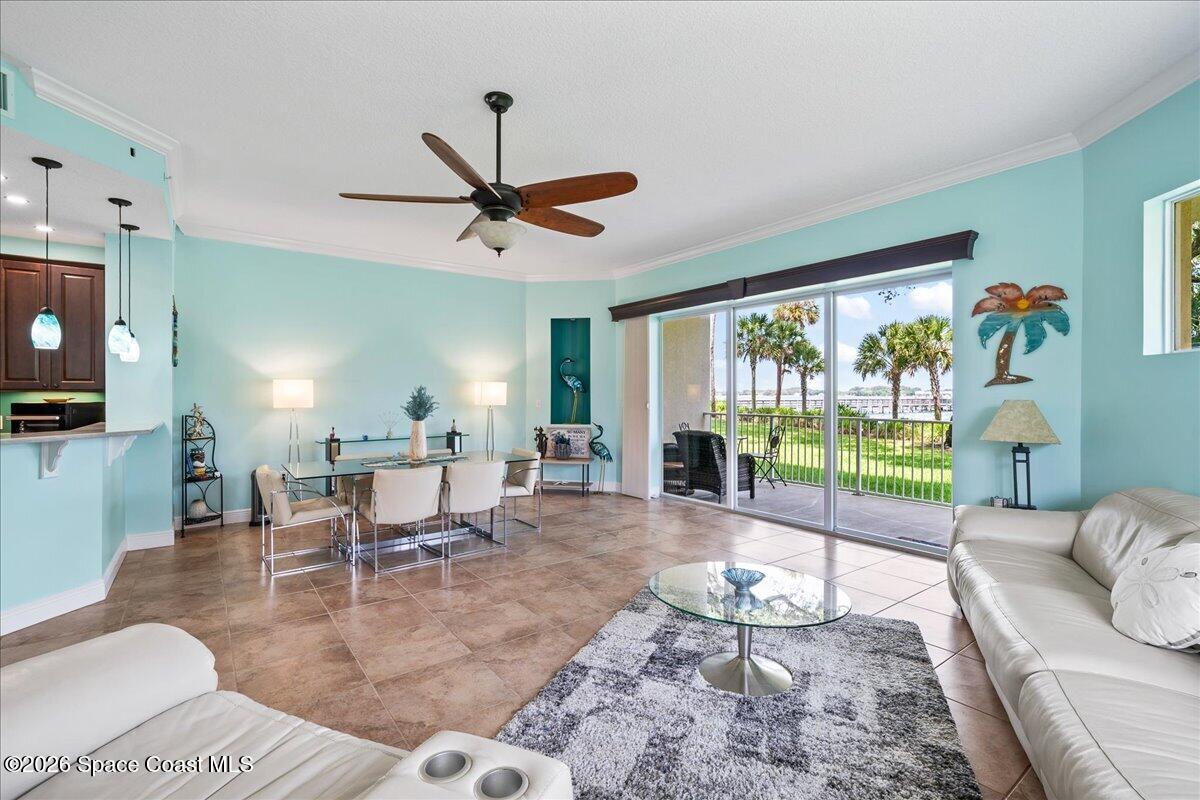 6005 Highway 1, Unit 101 Rockledge, FL 32955 - Photo 18 of 57 a living room with furniture and a floor to ceiling window