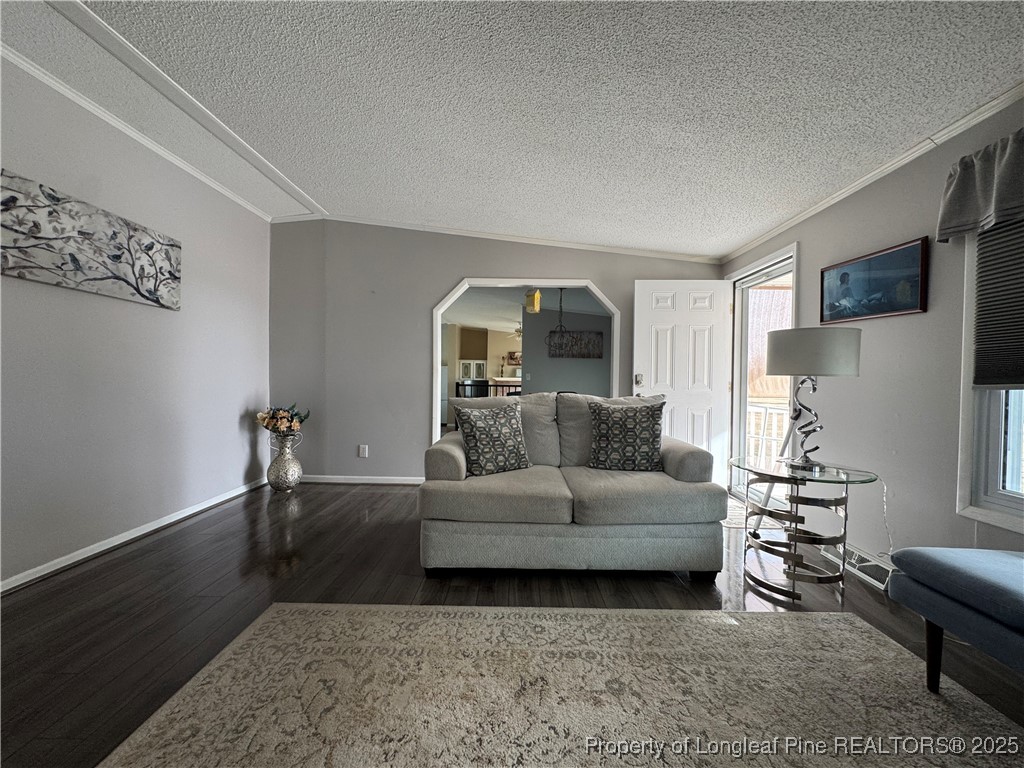 100 Wallace McClean Road Raeford, NC 28376 - Photo 12 of 38 a living room with furniture and a wooden floor