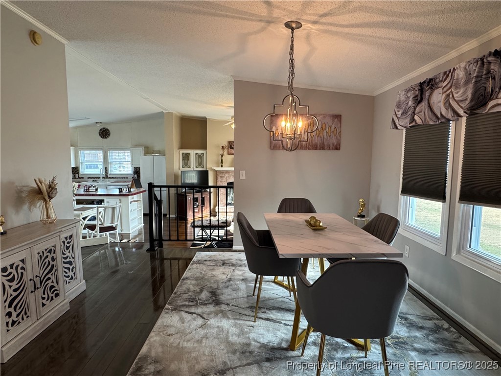 100 Wallace McClean Road Raeford, NC 28376 - Photo 13 of 38 a view of a dining room with furniture and a chandelier