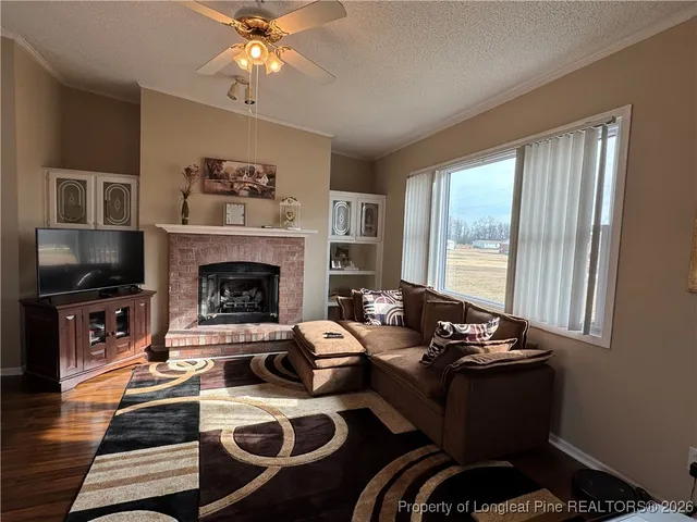 a living room with furniture fireplace and flat screen tv
