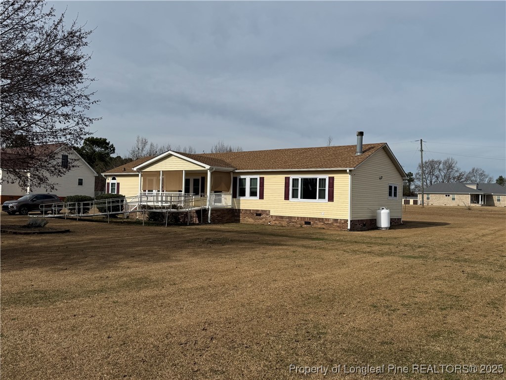 100 Wallace McClean Road Raeford, NC 28376 - Photo 2 of 38 a front view of a house with a yard