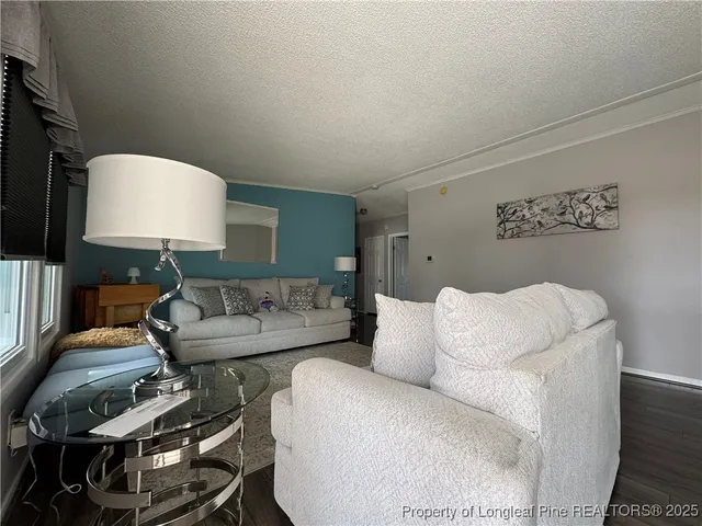 a living room with furniture and a lamp