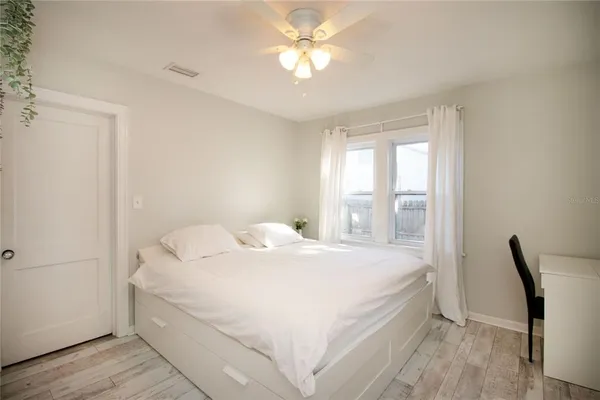 a bedroom with a bed and a window