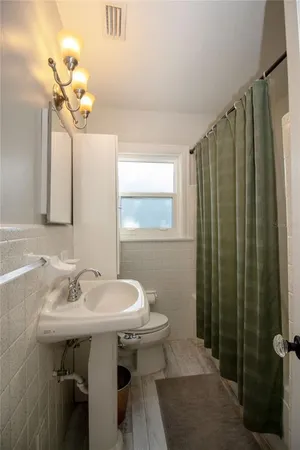 a bathroom with a sink a mirror and a toilet