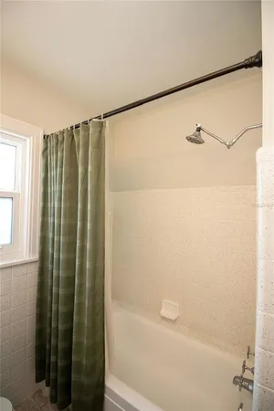 a bathroom with a shower and a tub