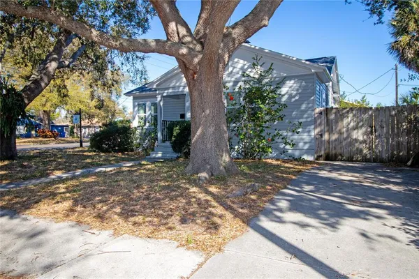 a view of a house with a tree