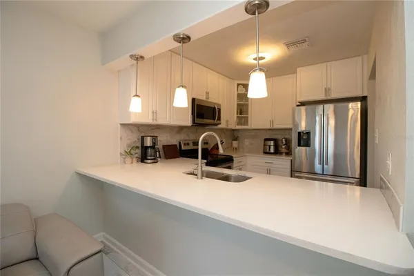 a kitchen with a refrigerator a sink and a stove