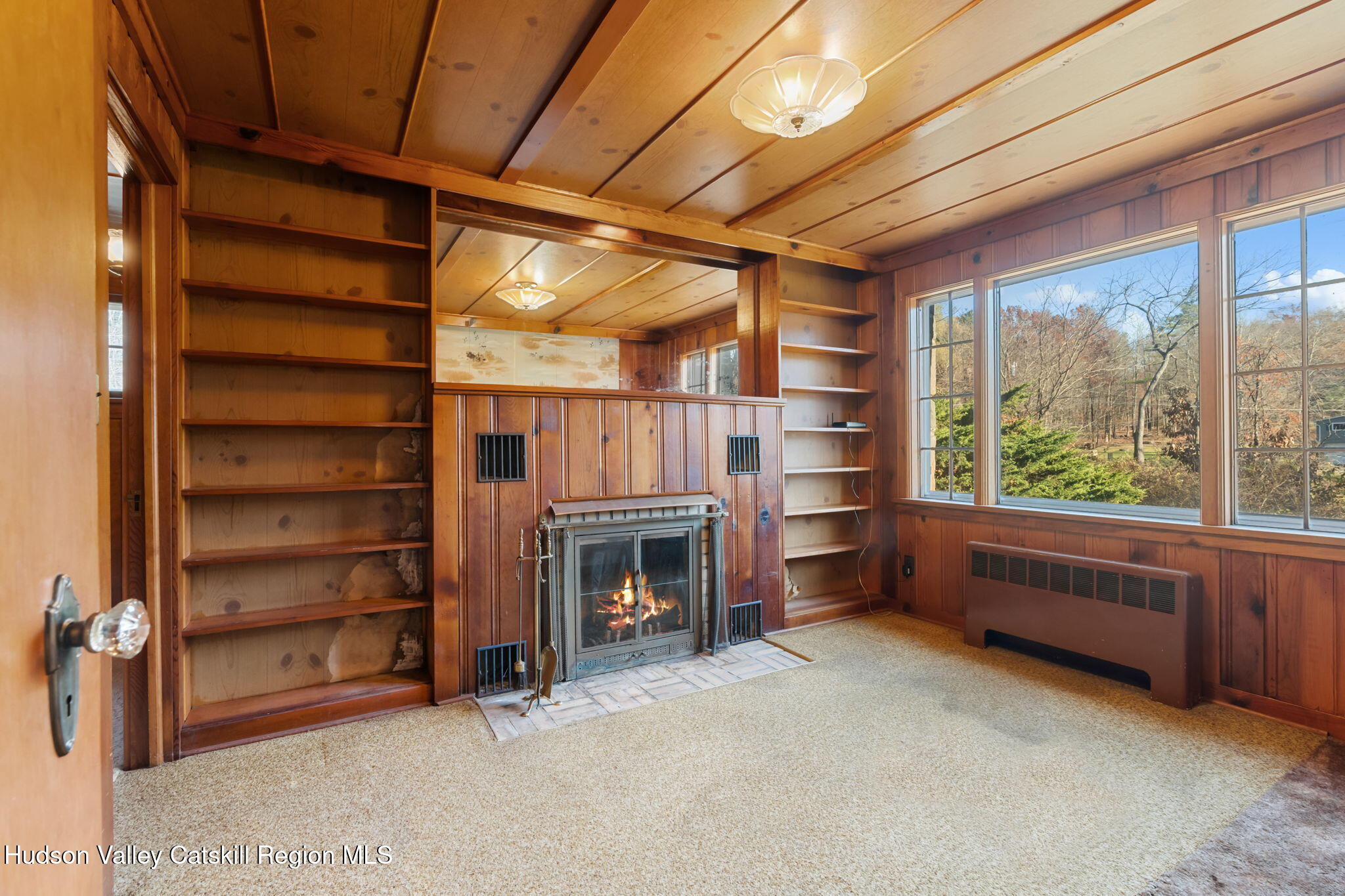 17 Bostock Road Shokan, NY 12481 - Photo 20 of 66 a view of an empty room with a fireplace and a window