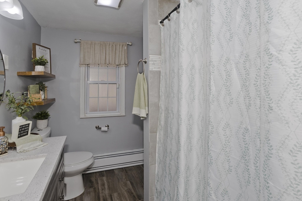1815 Parker Street Springfield, MA 01128 - Photo 16 of 33 a bathroom with a toilet a sink and curtain