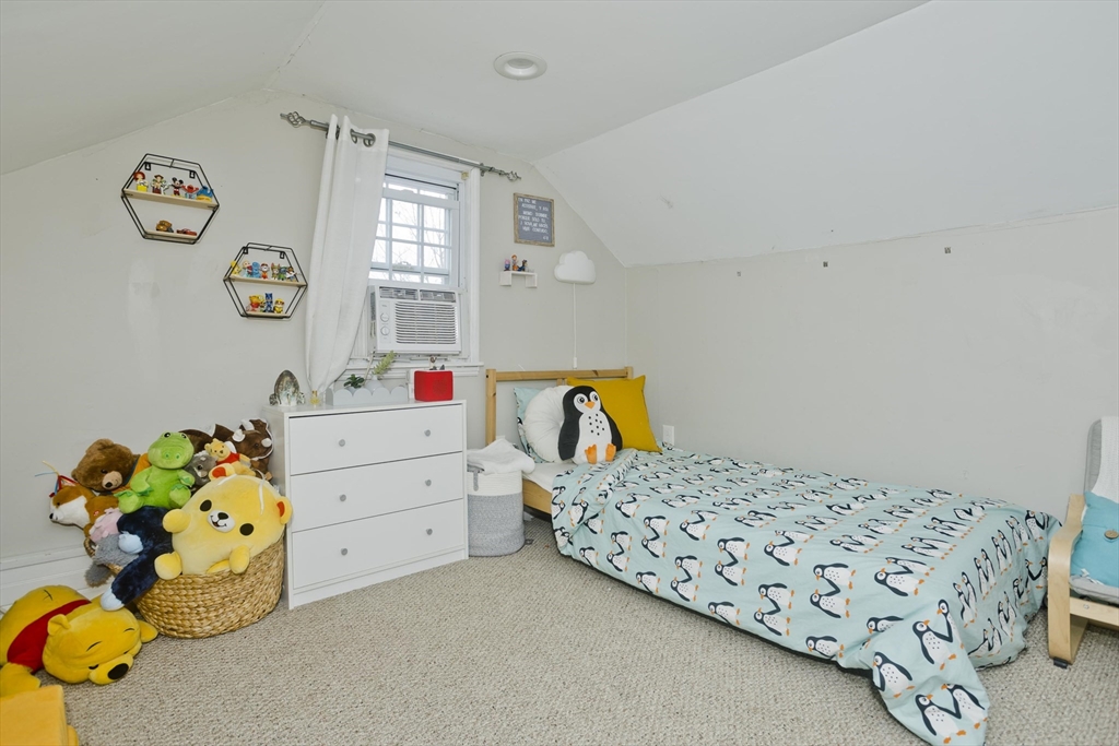 1815 Parker Street Springfield, MA 01128 - Photo 22 of 33 a bedroom with a bed and a dresser