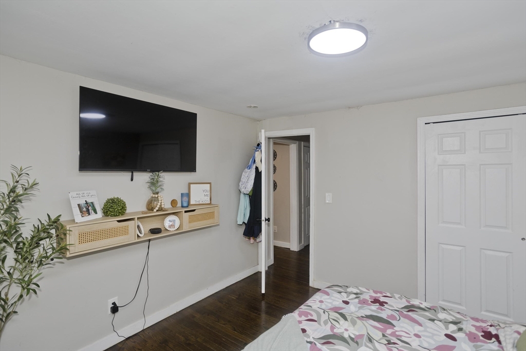 1815 Parker Street Springfield, MA 01128 - Photo 25 of 33 a bedroom with a bed and a flat screen tv