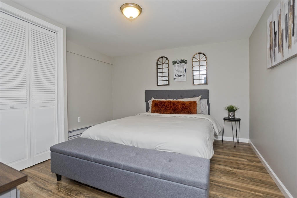 1815 Parker Street Springfield, MA 01128 - Photo 26 of 33 a bedroom with a bed and painting on the wall