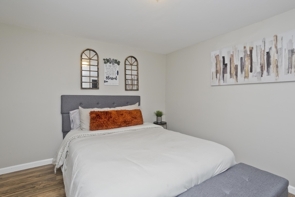 1815 Parker Street Springfield, MA 01128 - Photo 27 of 33 a bedroom with a bed and painting on the wall