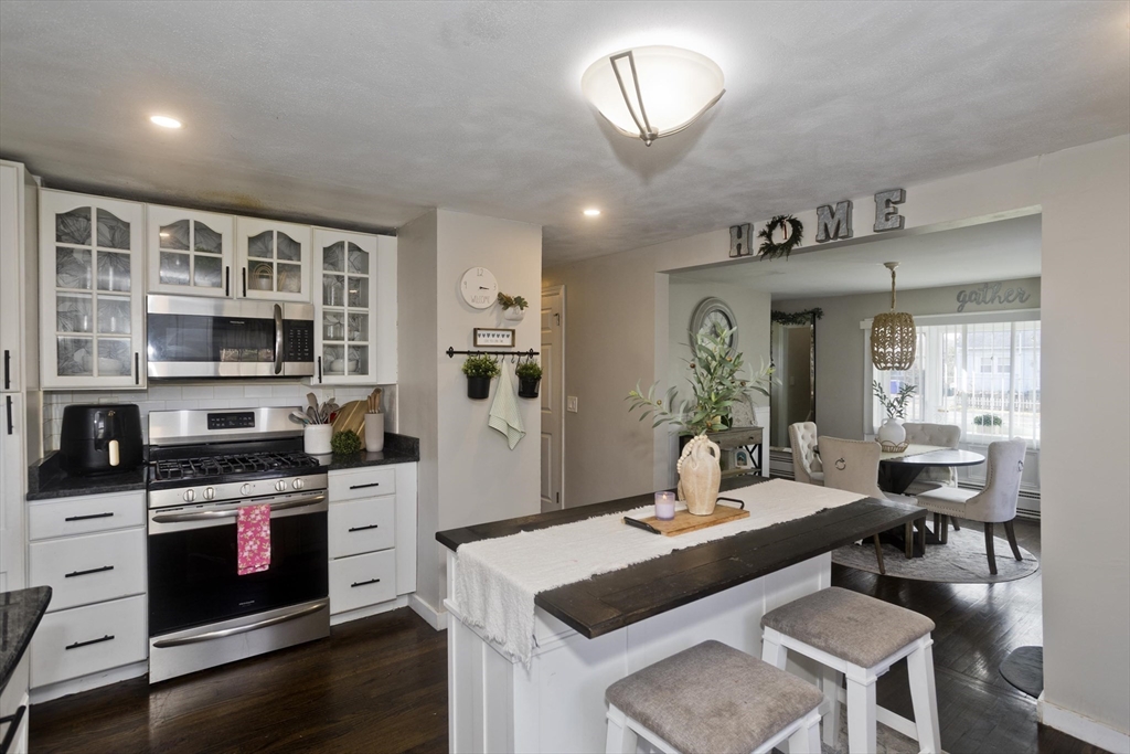 1815 Parker Street Springfield, MA 01128 - Photo 9 of 33 a kitchen with stainless steel appliances granite countertop a stove and a sink