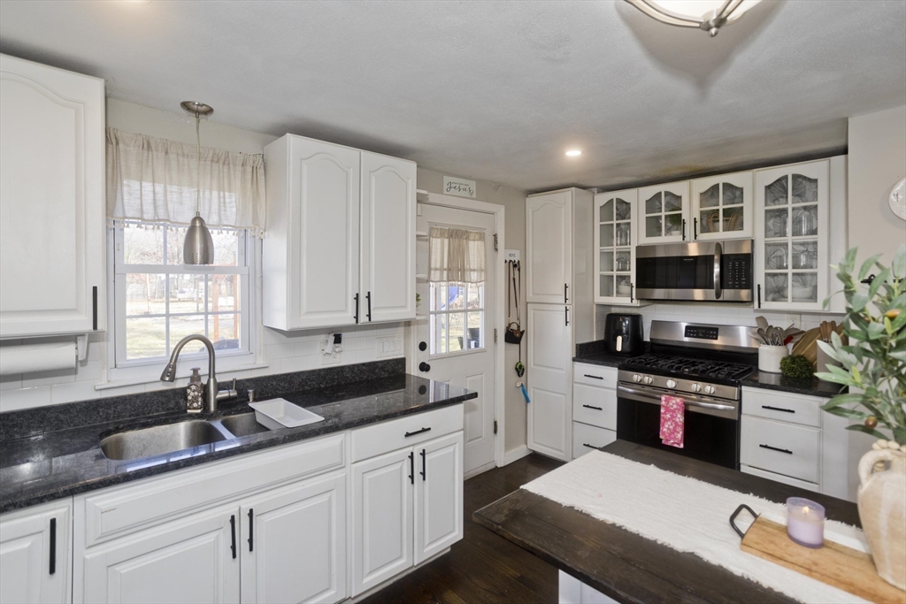 1815 Parker Street Springfield, MA 01128 - Photo 10 of 33 a kitchen with stainless steel appliances granite countertop a sink and cabinets
