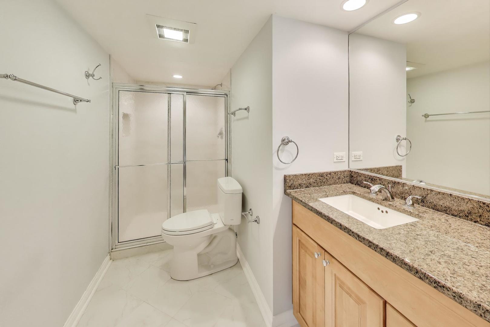 6411 Elm Street Morton Grove, IL 60053 - Photo 36 of 49 a bathroom with a sink toilet and shower