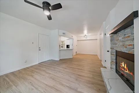 a view of empty room with a fireplace and window