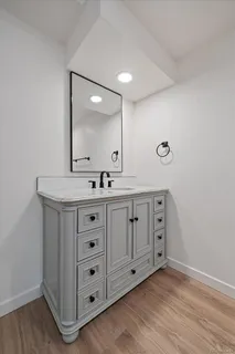 a bathroom with a double vanity sink and mirror