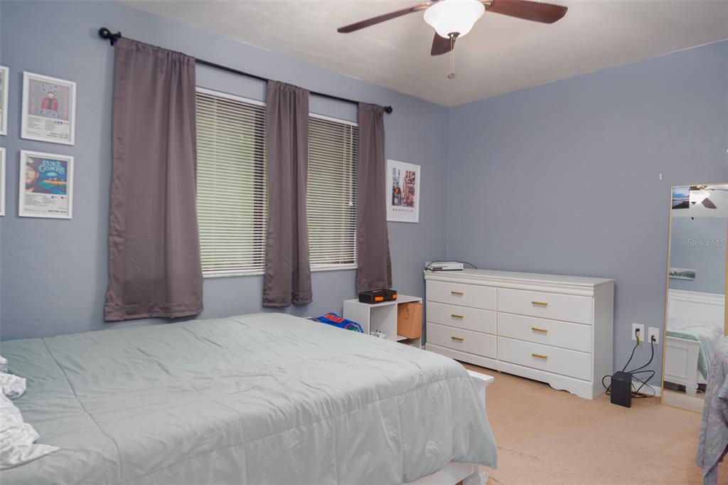2300 Southwest 43rd Street, Unit K5 Gainesville, FL 32607 - Photo 13 of 18 a bedroom with a bed and a chandelier