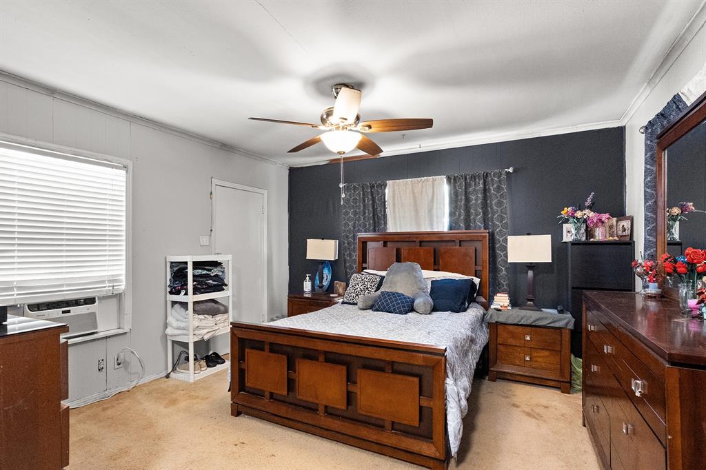 7826 Rilla Avenue Dallas, TX 75217 - Photo 2 of 10 Bedroom featuring light colored carpet, crown molding, and ceiling fan