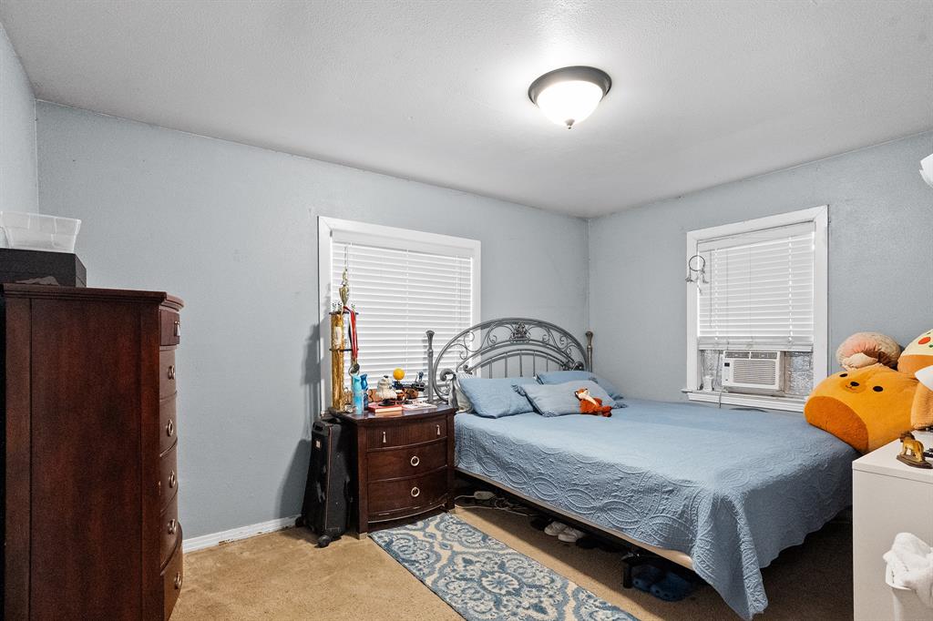 7826 Rilla Avenue Dallas, TX 75217 - Photo 3 of 10 Bedroom featuring light colored carpet and cooling unit