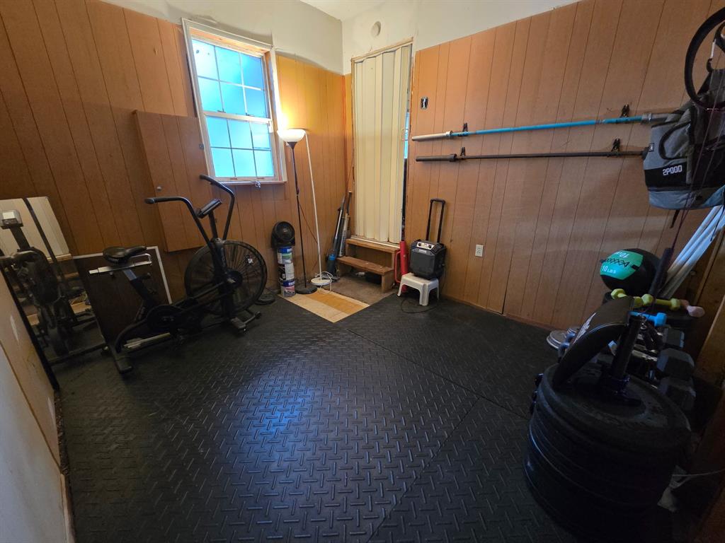 7826 Rilla Avenue Dallas, TX 75217 - Photo 10 of 10 Exercise area featuring wooden walls