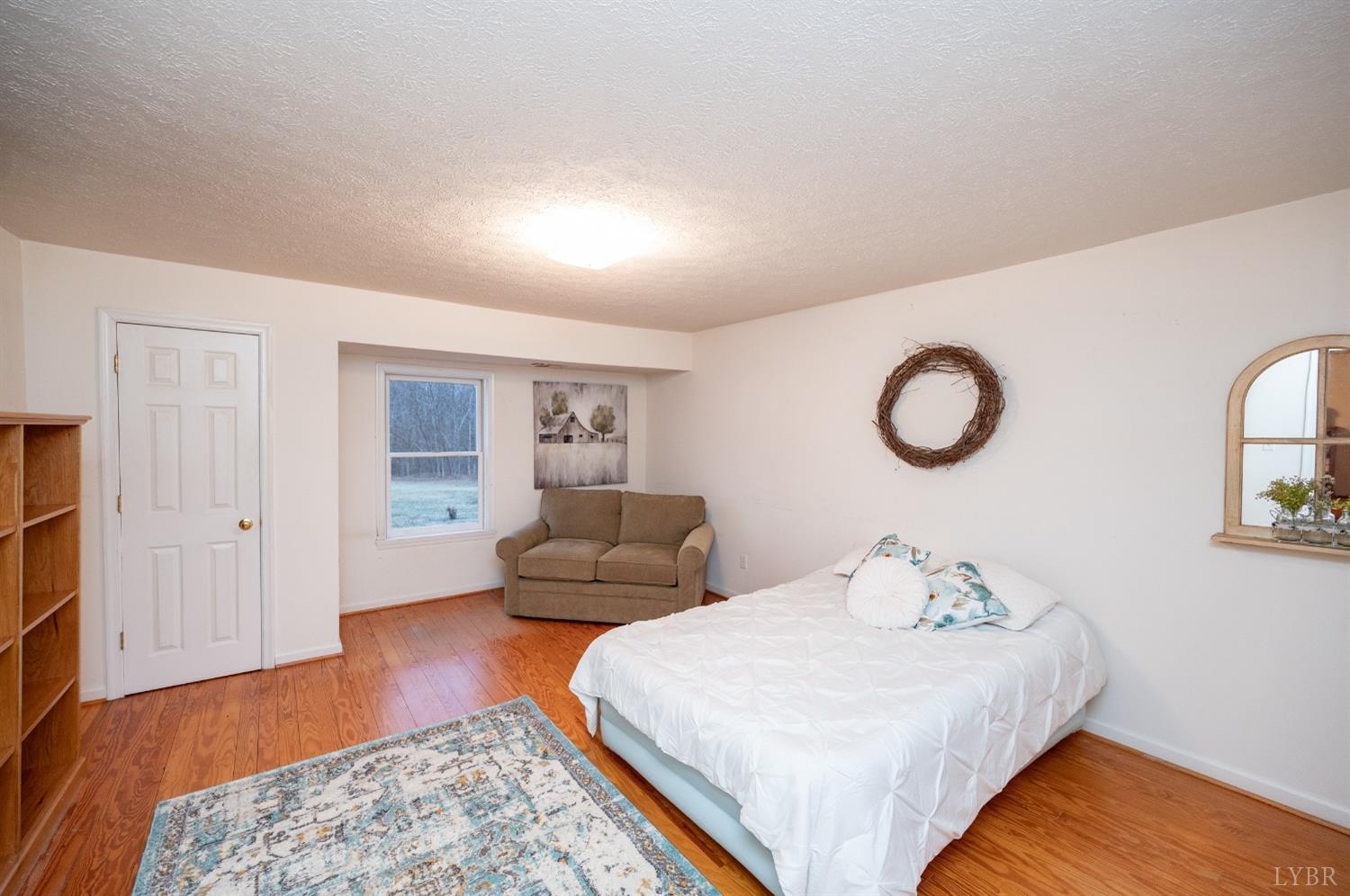 1394 Lowesville Road Amherst, VA 24521 - Photo 20 of 38 a bedroom with bed and wooden floor