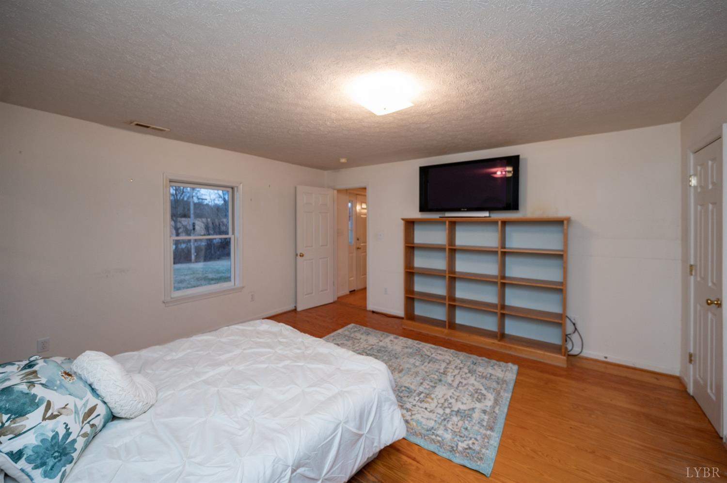 1394 Lowesville Road Amherst, VA 24521 - Photo 21 of 38 a bedroom with a bed and a television