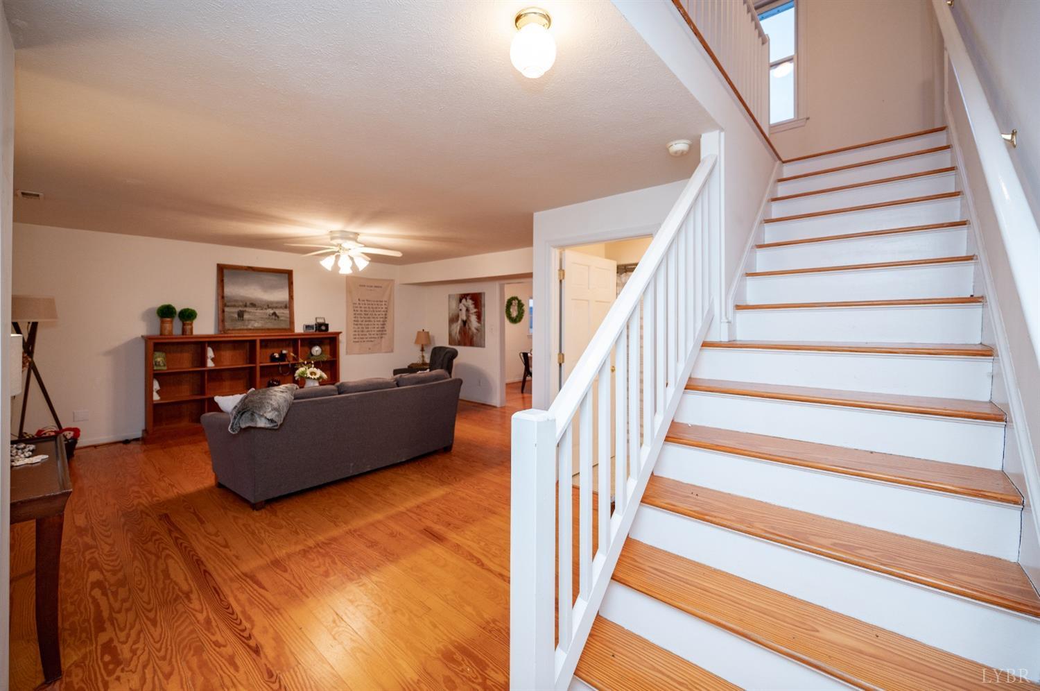 1394 Lowesville Road Amherst, VA 24521 - Photo 23 of 38 a living room with furniture and a dining table with wooden floor