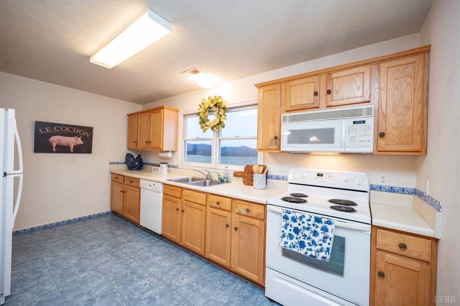 1394 Lowesville Road Amherst, VA 24521 - Photo 26 of 38 a kitchen with stainless steel appliances a sink stove and cabinets