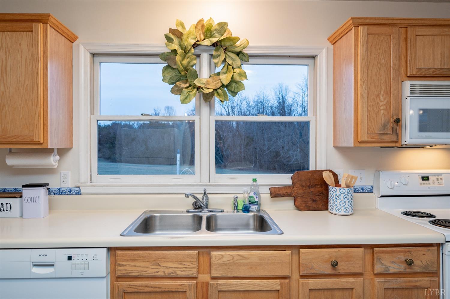 1394 Lowesville Road Amherst, VA 24521 - Photo 28 of 38 a kitchen with a sink a counter and cabinets