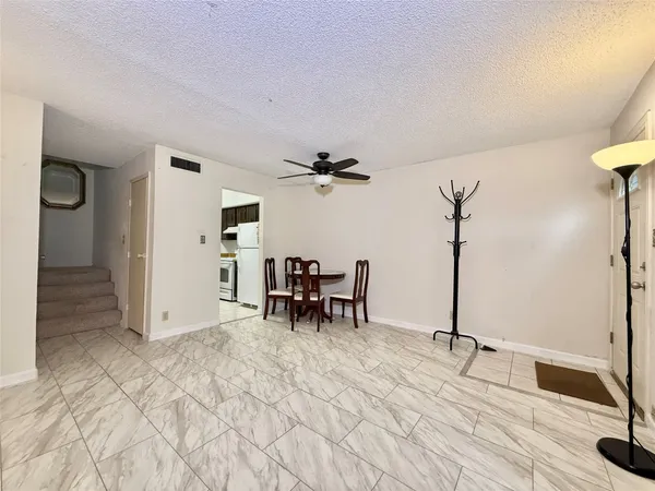 a view of a livingroom with furniture and a ceiling fan