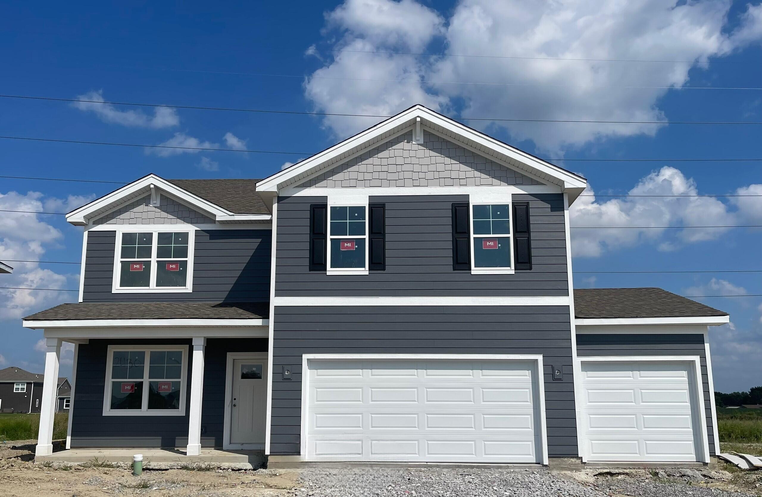 a front view of a house with garage
