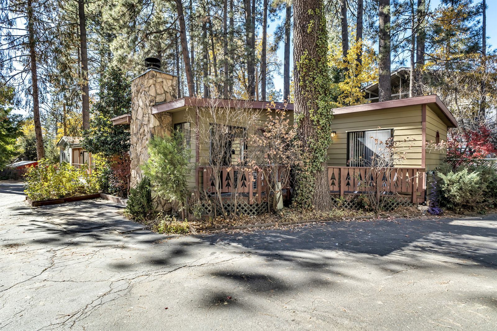 25955 Highway 243, Unit 18 Idyllwild, CA 92549 - Photo 1 of 46 a view of a brick house with large windows and a tree