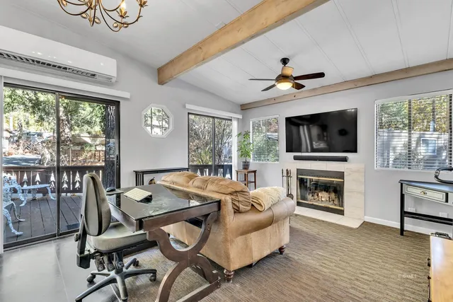 a living room with furniture and a chandelier