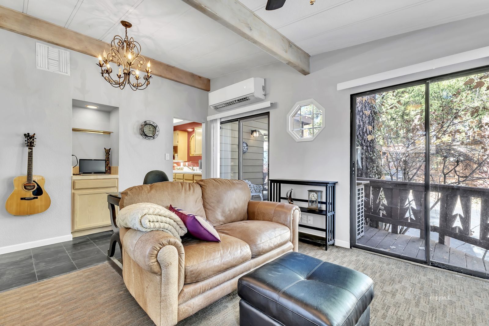 25955 Highway 243, Unit 18 Idyllwild, CA 92549 - Photo 17 of 46 a living room with furniture and a chandelier